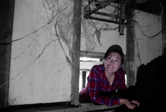 Christy Runnion, EIT &mdash; co-owner of IECertify and founder of BidEcho, smiling during a residential crawlspace inspection